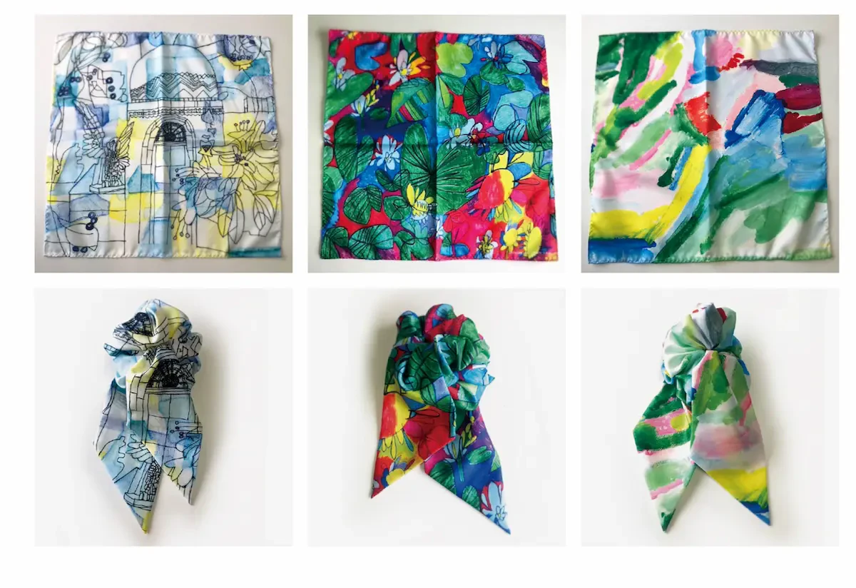 アール・ブリュット作家の杉山勇輔さん、大石理央さん、荒井麻理子さんの作品が採用されたスカーフの写真